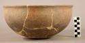 Potsherds and 5 red bowls; large red jar, fragmentary; bowl, incised decoration,