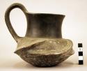 Tall-necked black ware vessel, incised decoration