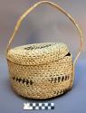 Straw carrying basket with black decoration