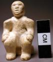 Carving - wooden figure of a seated man
