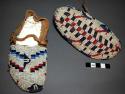 Pair of Sioux child's fully beaded moccasins. White background, geometric design