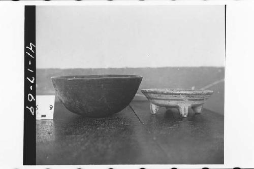 Left black ware bowl; right: black and red on orange tetrapod dish.