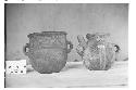 Two Red on Orange Jars, One with Handle Spout