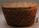 Coiled and imbricated cedar root oval basket (A) with lid (B)