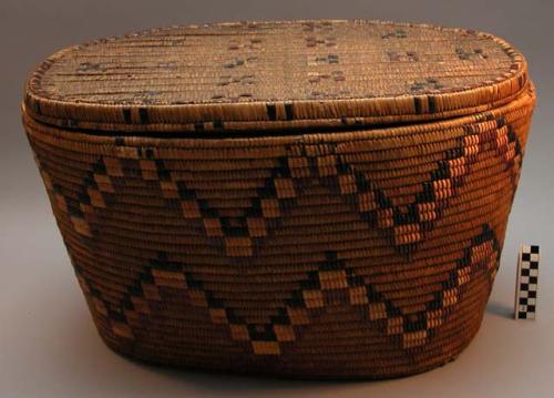 Coiled and imbricated cedar root oval basket (A) with lid (B)