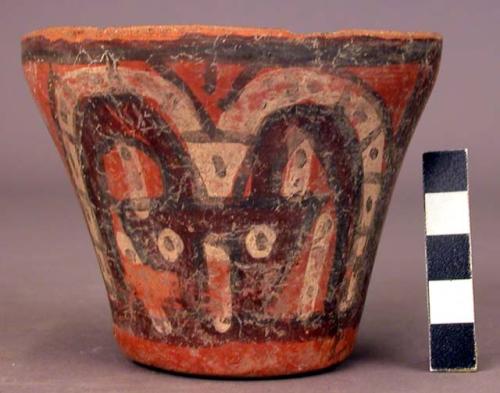 Polychrome pottery bowl - small stylized head design