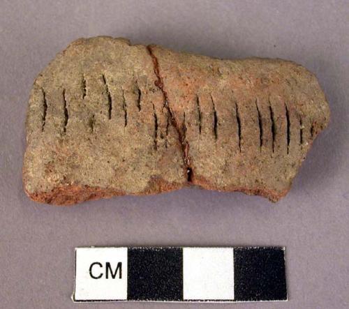 18 potsherds with various incised dashes decoration - red or black ware