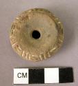 Pottery spindle whorl with incised and colored designs