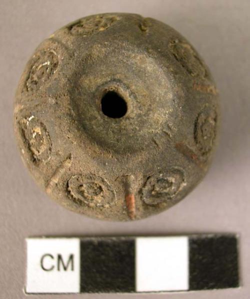 Pottery spindle whorl with incised and colored designs