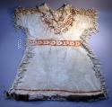 Woman's buckskin dress, fringed. High neck. Trimmed and ornamented with squirrel skin.