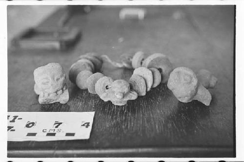 Spindle whorls and two small grotesque figures