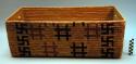 Coiled and imbricated cedar root rectangular basket: swastika motif