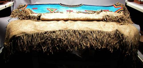 Sioux woman's buckskin dress with beaded yoke.