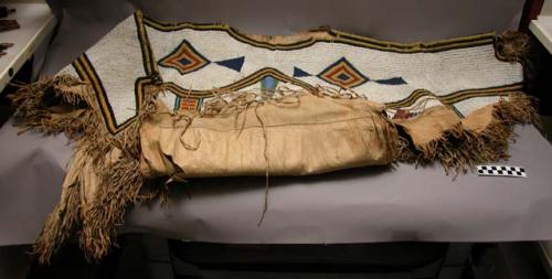 Plains woman's dress, probably Blackfoot. Made from buckskin, beaded.