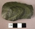 Stone artifact, deep grey green chert or flint?  Bifacial flaking, slightly conv