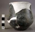 Ceramic jar, black burnished, round body, flat base, mended and reconstructed