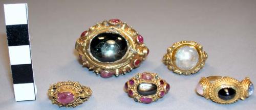 Gold ring inlaid with rubies and other stones