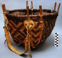 Twill basket with wooden framework and leather strap for carrying
