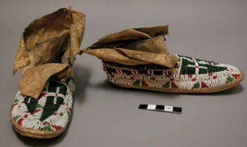 Pair of child's moccasins - green, white and orange bead decoration