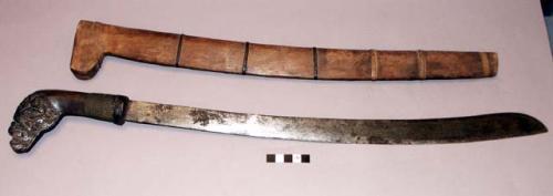 Sword with carved wooden handle and wooden sheath