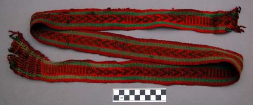 Belt, woven wool, brown geo. design & green stripes on red, webbed fringe