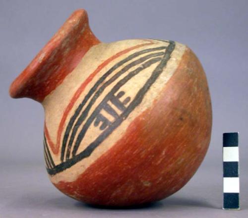 Pottery jar, red base with black and red ornament on upper yellow zone