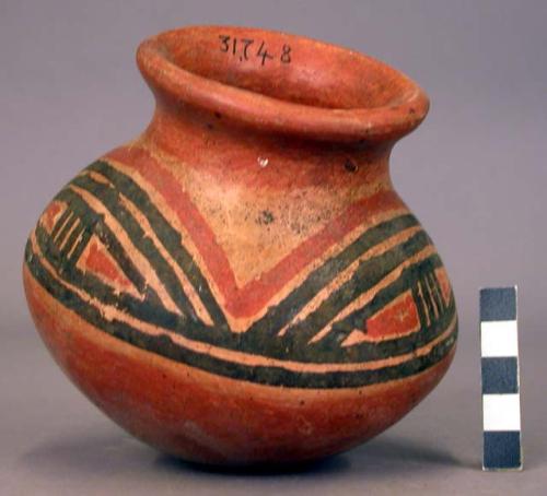 Pottery jar, red base with black and red ornament on upper yellow zone