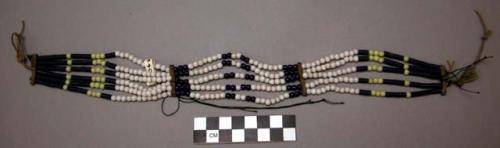Necklace, strands of blue, white & yellow glass beads attached to rawhide strips