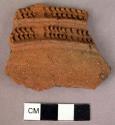 Red ware sherd - 2 ridges with involved rolled or stamped pattern between