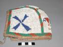 Sioux beaded child's cap. Made from leather, lined and trimmed w/ cloth. Exterio