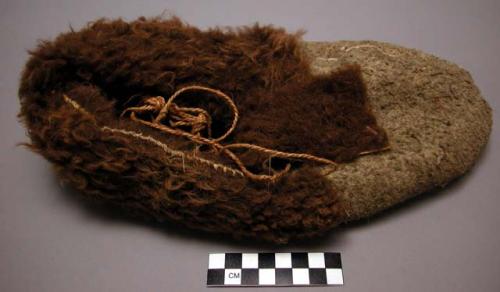 Man's winter moccasin, buffalo skin. Hemp twine strings. Sewn with sinew.