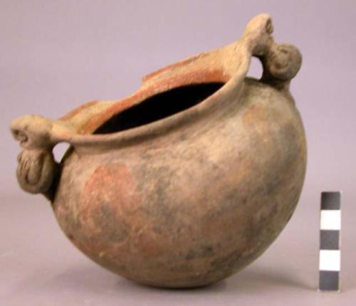 Pottery jar, handles connected with lip, plastic work and rudely carved to