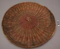 Wicker plaque, coiled. 3rd mesa type. badly faded one side. designs in red, blue