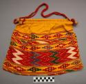 Knitting bag: red, green, purple and white geometric design on a yellow backgrou