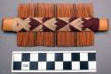Double sided wooden comb with white and purple cotton thread interwoven