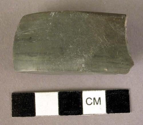 Ground stone axe, small, green, polished, butt broken