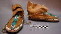 Pair of moccasins--skin with rawhide soles; beaded centrepiece and border