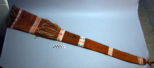 Gun case made from smoke-tanned moose hide. Bands of very fine quillwork