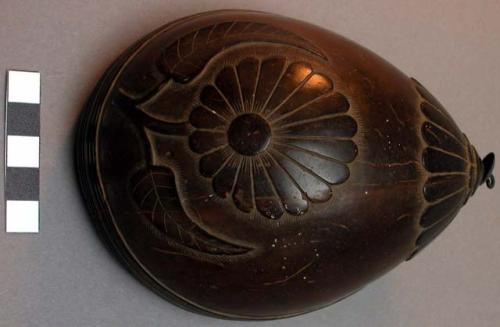 Saddle cup of cocoanut shell carved with single flower design