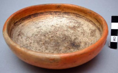 Hopi bowl. Exterior is rust colored & polished. Interior is tan colored w/ black