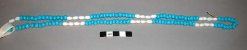 String of glass trade beads (necklace?). Pattern of white and light blue beads.