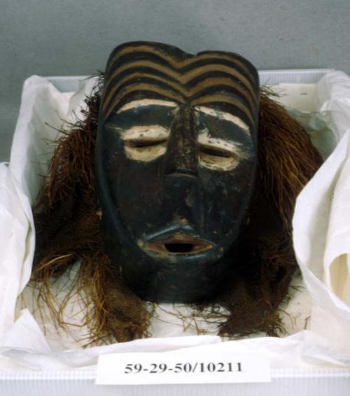 Wooden mask with plant fiber and bast fiber textile headdress