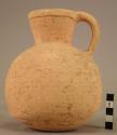 Round bodied, narrow necked pottery jug with dimples base and 1 handle;