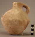 Round-bottomed biconical pottery pitcher with pinched spout