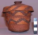 Tlingit closed twine basket with lid. Two bands of false embroidery.