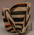 Tutu or bag made of wool with both natural stripes and chemically dyed stripes.
