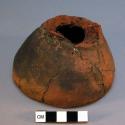 Fragment of a ceramic jar, either base or rim, mended, dark clay, thick