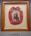 Photograph of Sitting Bull, framed with kerchief he wore when shot.