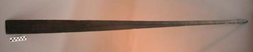 Paddle or club carved from black wood remnants of wound thread near +