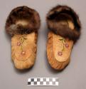 Pair of moccasins edged with fur. floral decoration in purple and green